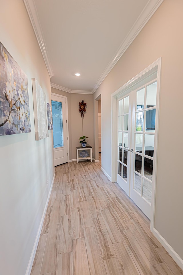 corridor featuring french doors, ornamental molding, and a wealth of natural light