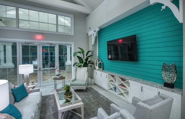 sunroom featuring french doors and lofted ceiling