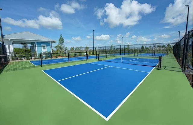 view of tennis court featuring basketball hoop