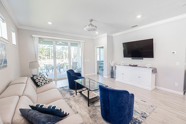 living room with ornamental molding and light hardwood / wood-style floors