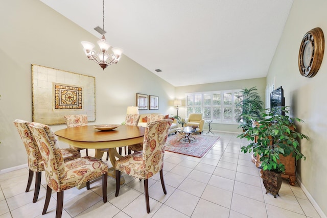 tiled dining space featuring vaulted ceiling and a notable chandelier