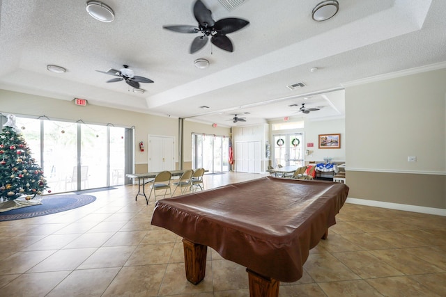 playroom with light tile patterned floors, a tray ceiling, a healthy amount of sunlight, and billiards