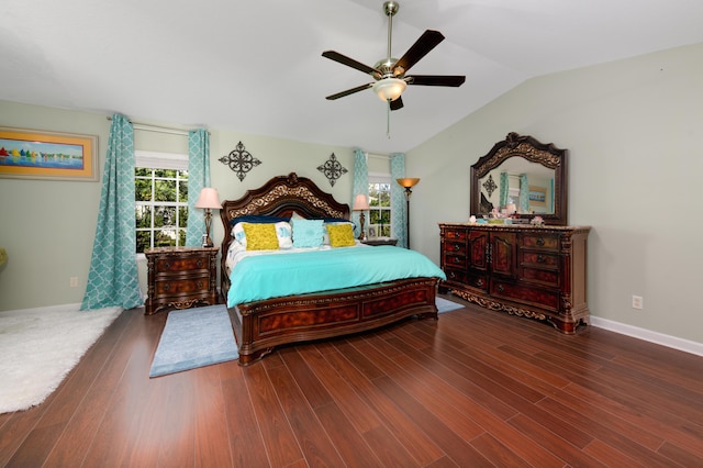 bedroom with ceiling fan, dark hardwood / wood-style flooring, and vaulted ceiling