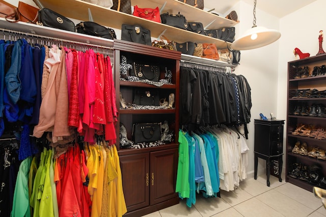 spacious closet with light tile patterned floors