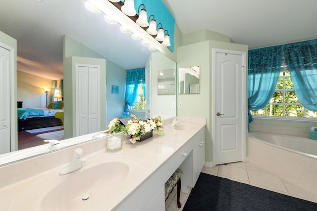 bathroom with tile patterned flooring, vanity, and a tub to relax in