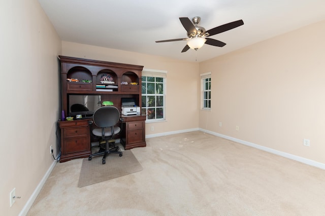 home office featuring ceiling fan and light carpet