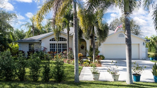 ranch-style house featuring a garage and a front lawn