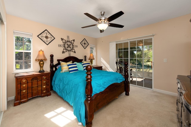 bedroom with access to exterior, light colored carpet, and ceiling fan