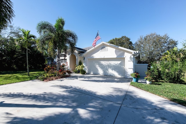 view of front of house featuring a front yard and a garage