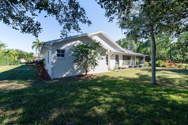 view of side of home with a lawn