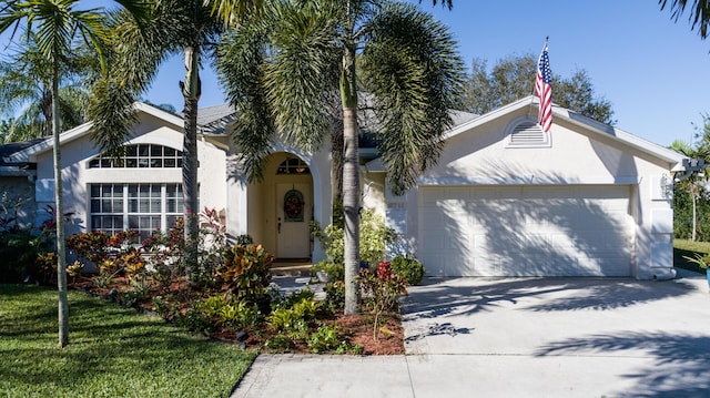 view of front of home featuring a garage and a front lawn