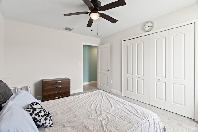 bedroom featuring ceiling fan, a closet, and light colored carpet