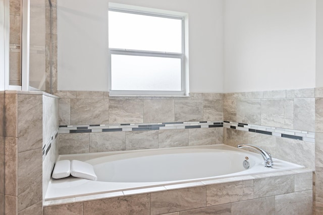 bathroom featuring tiled tub