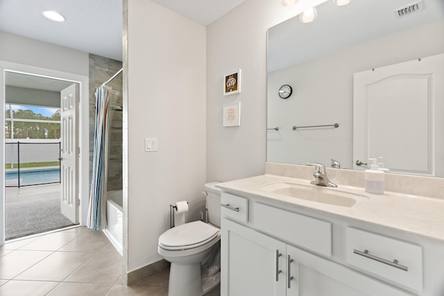 full bathroom featuring toilet, vanity, tile patterned floors, and shower / tub combo with curtain