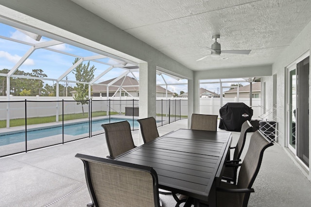 sunroom featuring a pool and ceiling fan