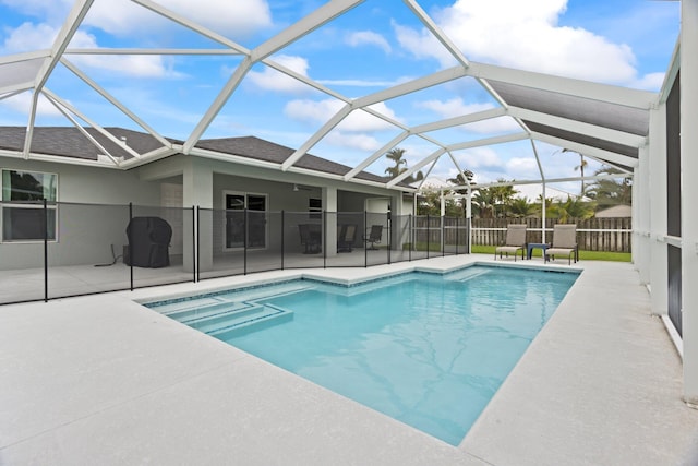 view of swimming pool with a lanai and a patio area