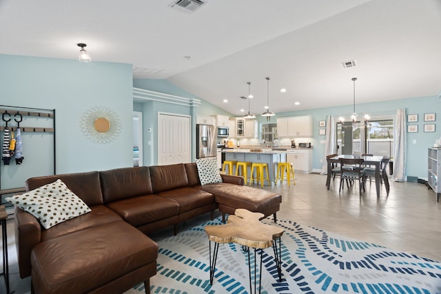 tiled living room featuring a chandelier and lofted ceiling