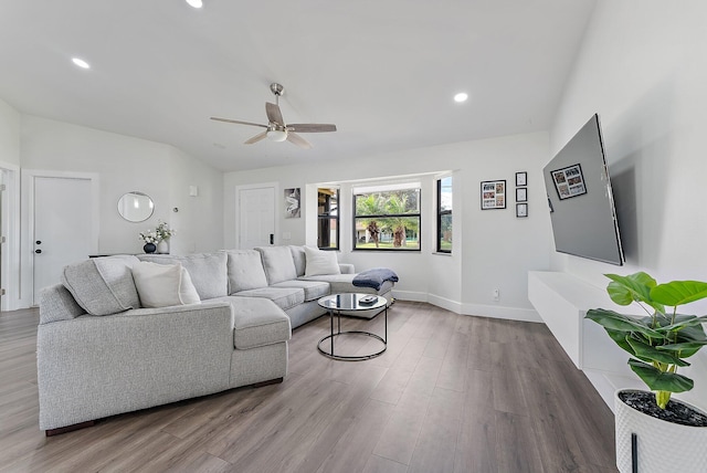 living room featuring hardwood / wood-style floors and ceiling fan