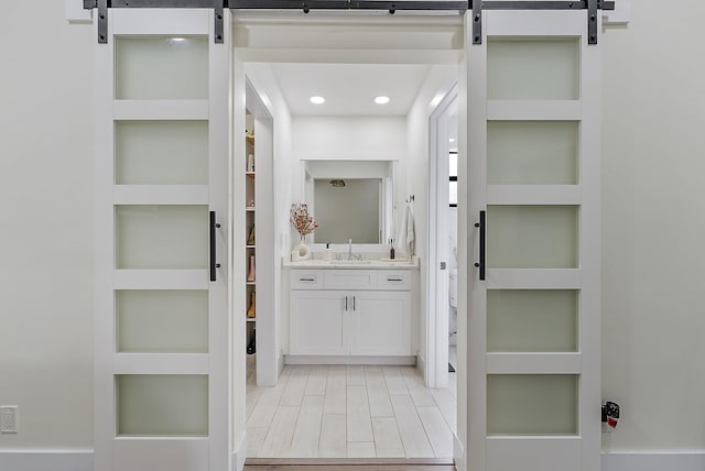 bathroom featuring built in shelves and vanity