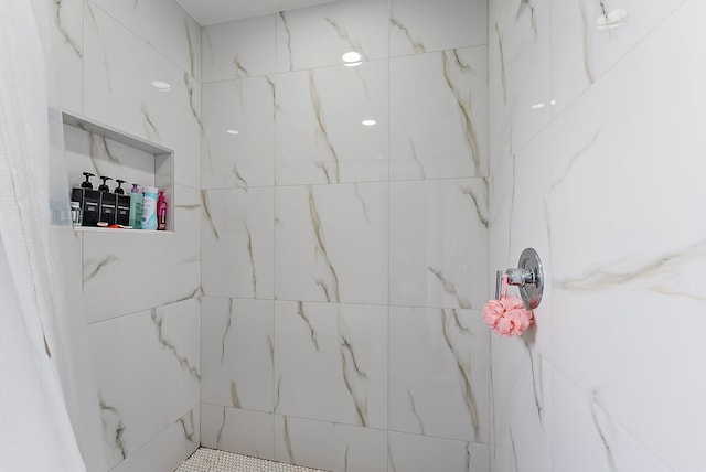 bathroom with tiled shower