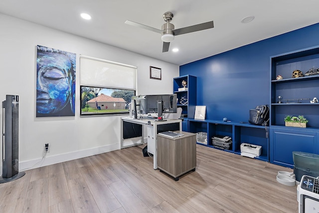 home office featuring built in shelves, light wood-type flooring, and ceiling fan