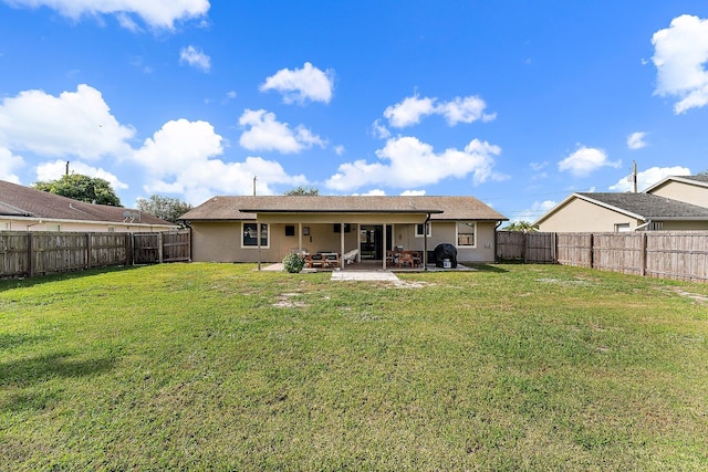 rear view of property with outdoor lounge area, a yard, and a patio area