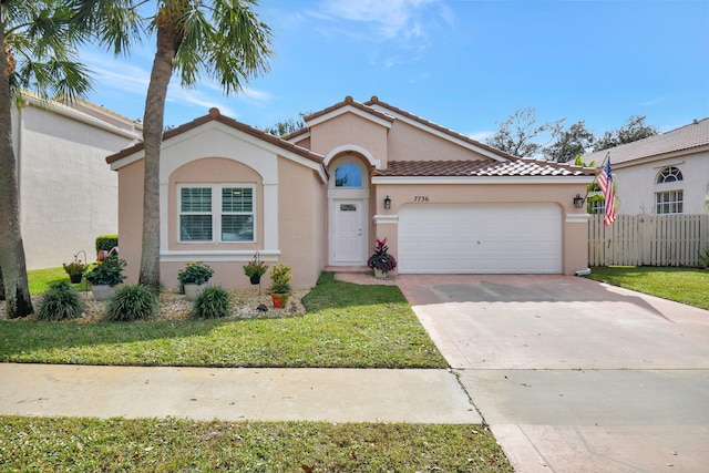 mediterranean / spanish house with a garage and a front yard