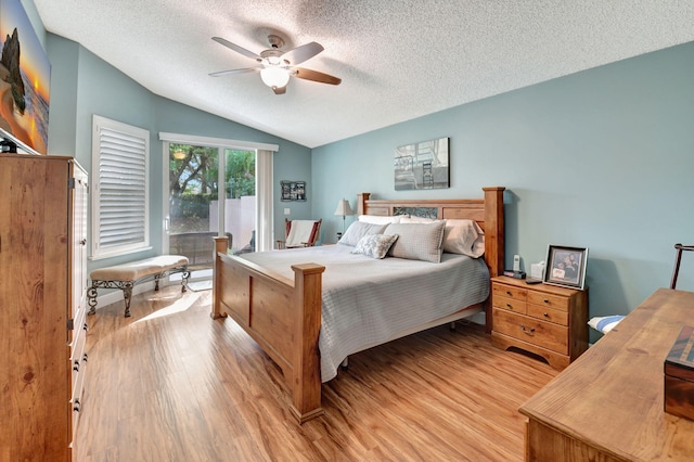 bedroom featuring a textured ceiling, ceiling fan, lofted ceiling, and light wood-type flooring