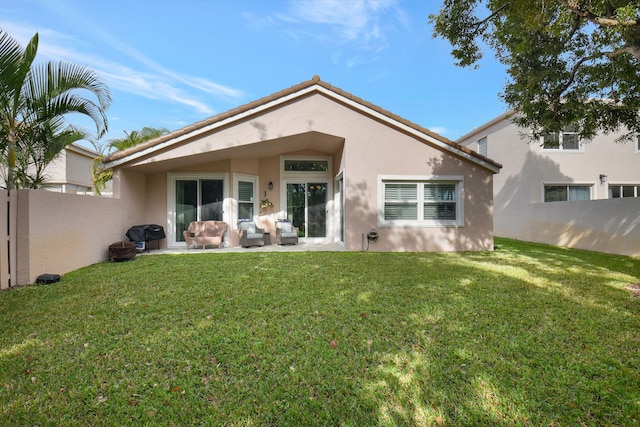 rear view of house with an outdoor living space and a yard