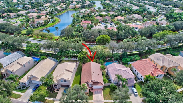 birds eye view of property with a water view