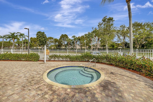 view of pool with a hot tub