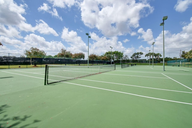 view of tennis court with basketball hoop