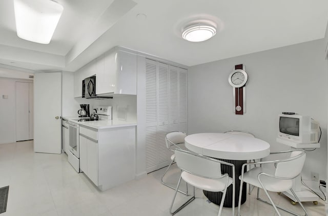 kitchen with white cabinetry and white electric stove