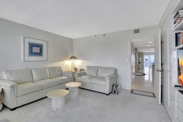 living room with light carpet and a textured ceiling