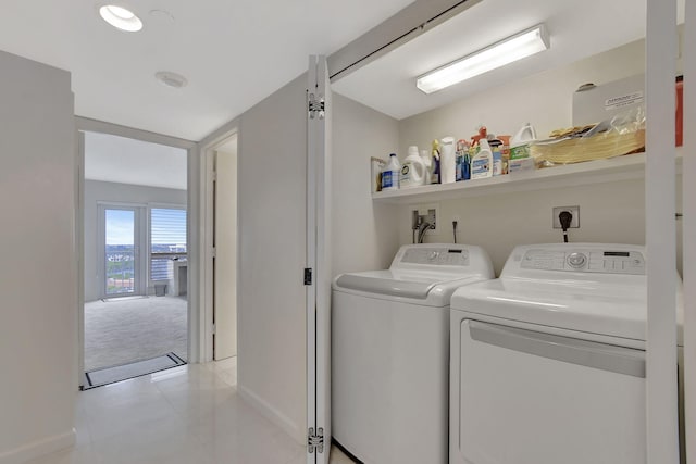 laundry room with light tile patterned floors and washing machine and clothes dryer