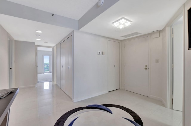 corridor with light tile patterned floors