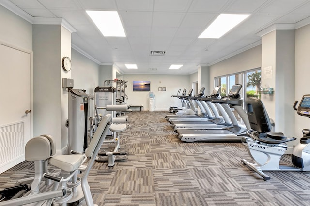 workout area featuring carpet flooring and crown molding