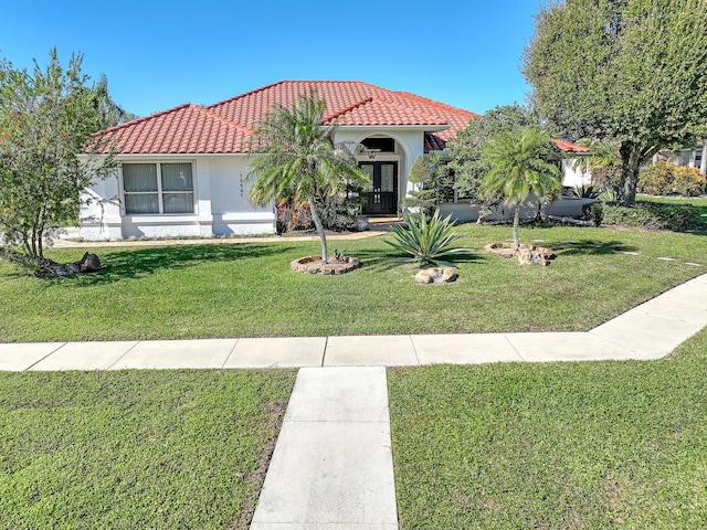 mediterranean / spanish-style home featuring a front yard