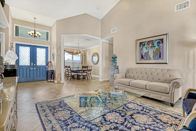 tiled living room with french doors, high vaulted ceiling, a notable chandelier, and crown molding