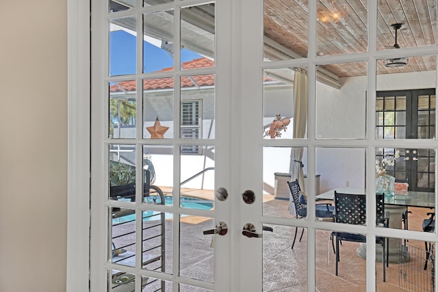 interior space featuring carpet flooring, a wealth of natural light, and french doors