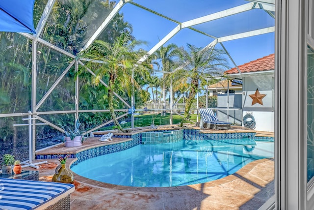 view of swimming pool with a lanai and a patio