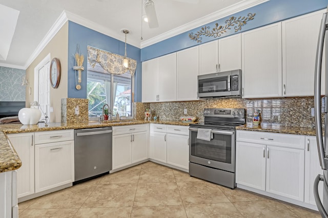 kitchen with tasteful backsplash, stainless steel appliances, decorative light fixtures, dark stone countertops, and white cabinetry