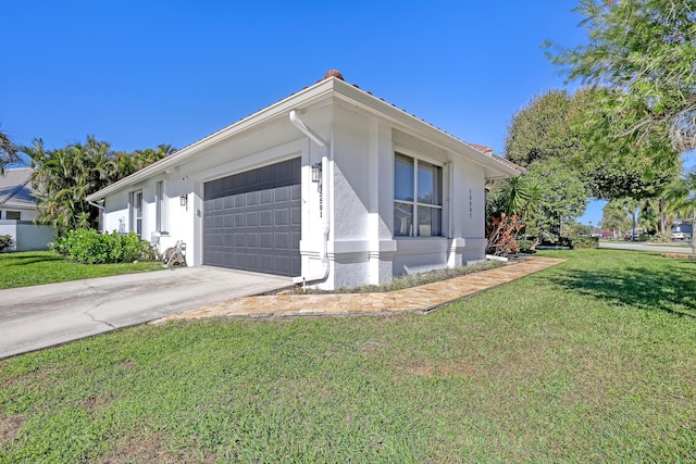 view of property exterior featuring a garage and a lawn