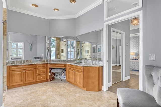 bathroom with crown molding, vanity, and a shower with shower door