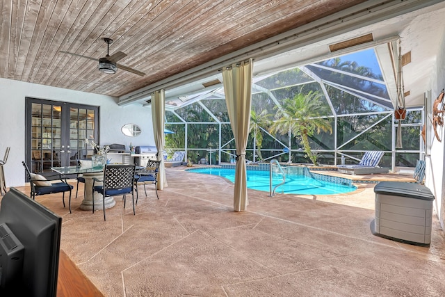 view of swimming pool featuring french doors, glass enclosure, ceiling fan, and a patio area