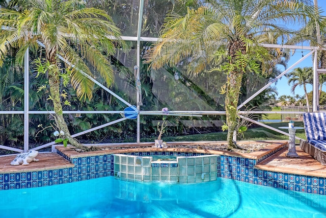 view of swimming pool with glass enclosure