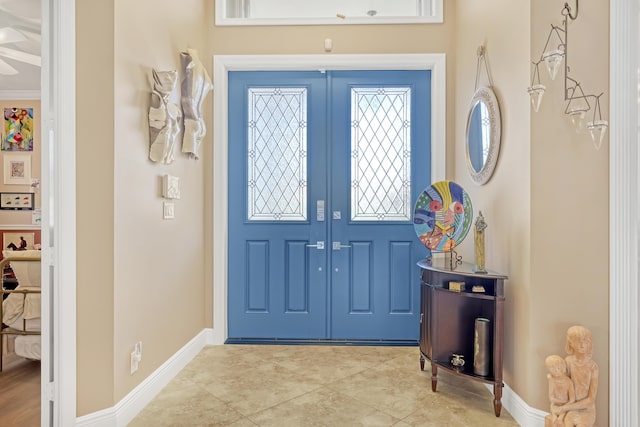 foyer featuring ornamental molding and french doors