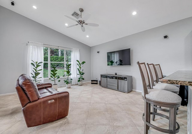 living room with vaulted ceiling, ceiling fan, and light tile patterned flooring