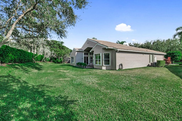 view of side of property with a lawn