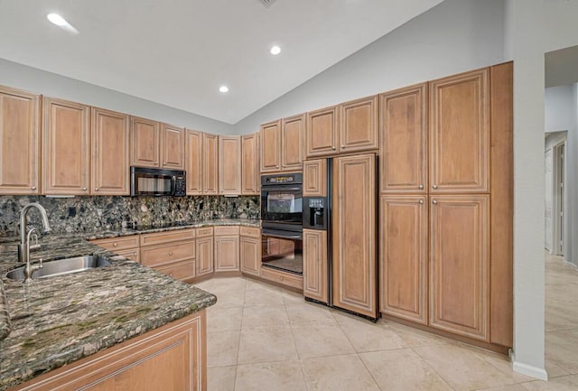 kitchen featuring backsplash, sink, black appliances, dark stone countertops, and lofted ceiling